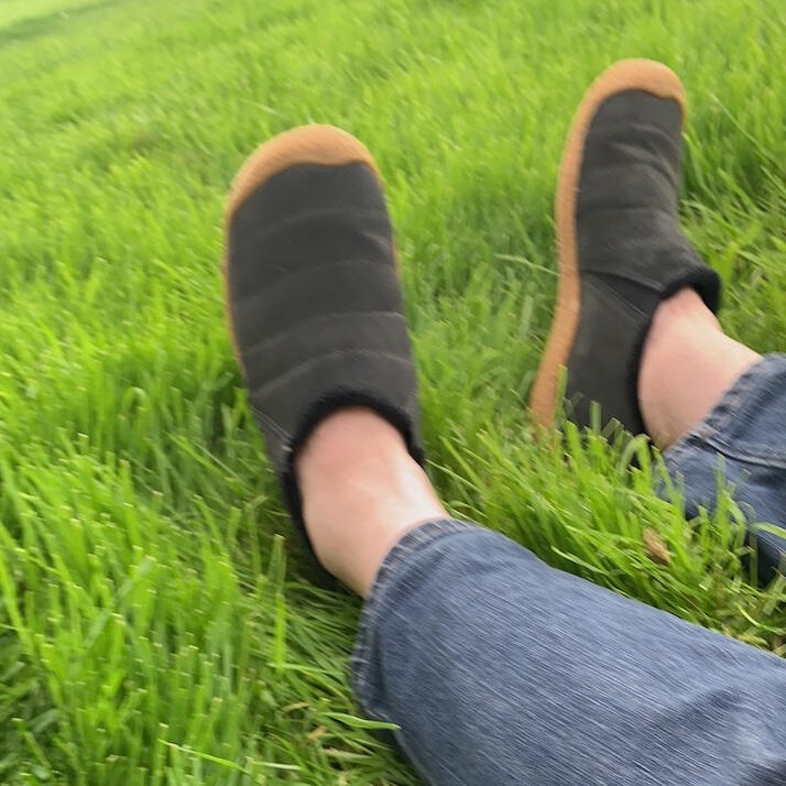 Feet resting on grass